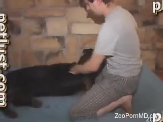 Dude with a hard cock fooling around with a dog