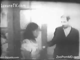 Naked woman in vintage zoo porn tape with a dog